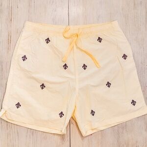 Castaway Soft Yellow Shorts with Purple Fleur De Lis details